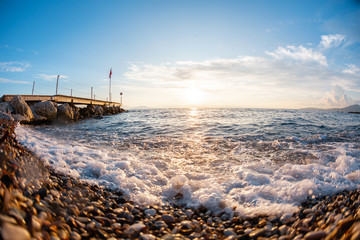 Wall Mural - Summer sunrise on coast, Corfu island, Greece. Beach with perfect views of the mainland Greece mountains.