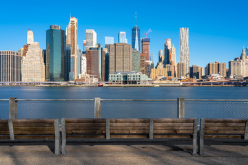 Fototapete - Scene of New york Cityscape river side with east river at the morning time under blue sky, USA downtown skyline, Architecture and building with tourist concept