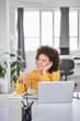 © nenadaksic - Charming mixed race businesswoman dressed casual holding eyeglasses and looking away while sitting in modern office.