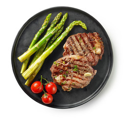 Wall Mural - plate of grilled steaks on white background