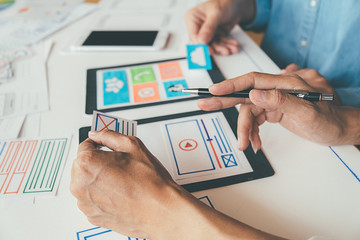 Wall Mural - Creative Web Designer planning application and developing template layout, framework for mobile phone. User experience (UX) concept.