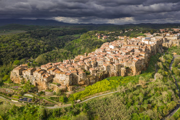 Wall Mural - Fly above old city in Tuscany in Italy in spring sunset.