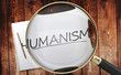 Study, learn and explore humanism - pictured as a magnifying glass enlarging word humanism, symbolizes analyzing, inspecting and researching the meaning of humanism, 3d illustration