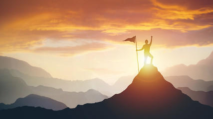silhouette of businessman with flag on mountain top over sky and sun light background