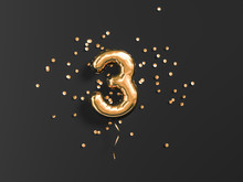 Three Year Birthday. Number 3 Flying Foil Balloon And Gold Confetti On Black. Tree-year Anniversary Background. 3d Rendering