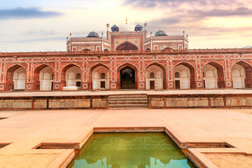 Fototapete - Humayun Tomb red sandstone architecture structure with stone carvings and arches. Humayun Tomb Delhi is a UNESCO World Heritage site.