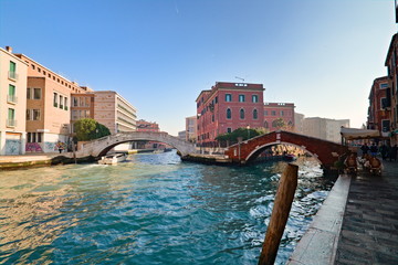 Typical view of the old city of Venice, Italy, with canals, bridges, ancient buildings immersed in water, boats and gondolas