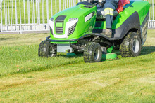 Ride Lawn Mower Mows A Green Fresh Grass.