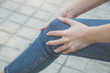 © TeTe Song - A beautiful slim girl,Woman having knee pain in park after she exercise.woman with knee pain .