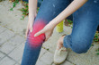 © TeTe Song - A beautiful slim girl,Woman having knee pain in park after she exercise.woman with knee pain .
