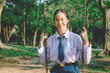 © TeTe Song - Portrait of asian girl student in school uniform Thailand style, sitting on swing and enjoy herself in windy and sunny day.
