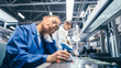© Gorodenkoff - Shot of a Tired Sleeping Female in Blue Work Coat at Her Working Place in Electronics Factory. High Tech Factory Facility with more Employees in the Background.