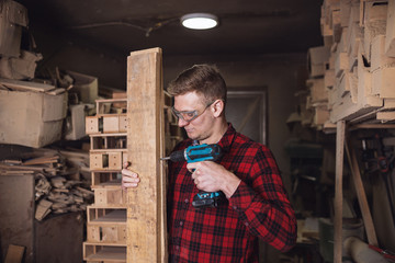 Wall Mural - Professional young carpenter using drill