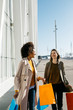 © Westend61 - Two happy women with shopping bags walking in the city
