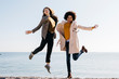 © Westend61 - Two happy friends jumping on the beach enjoying leisure time