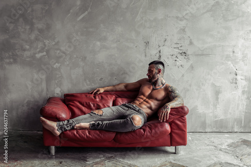 Fashion Portrait Of Sexy Naked Male Model With Tattoo And A