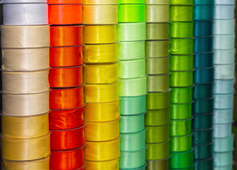 Colored satin ribbons on the counter of the store. Needlework