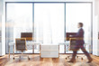 © ImageFlow - Man walking in panoramic manager office