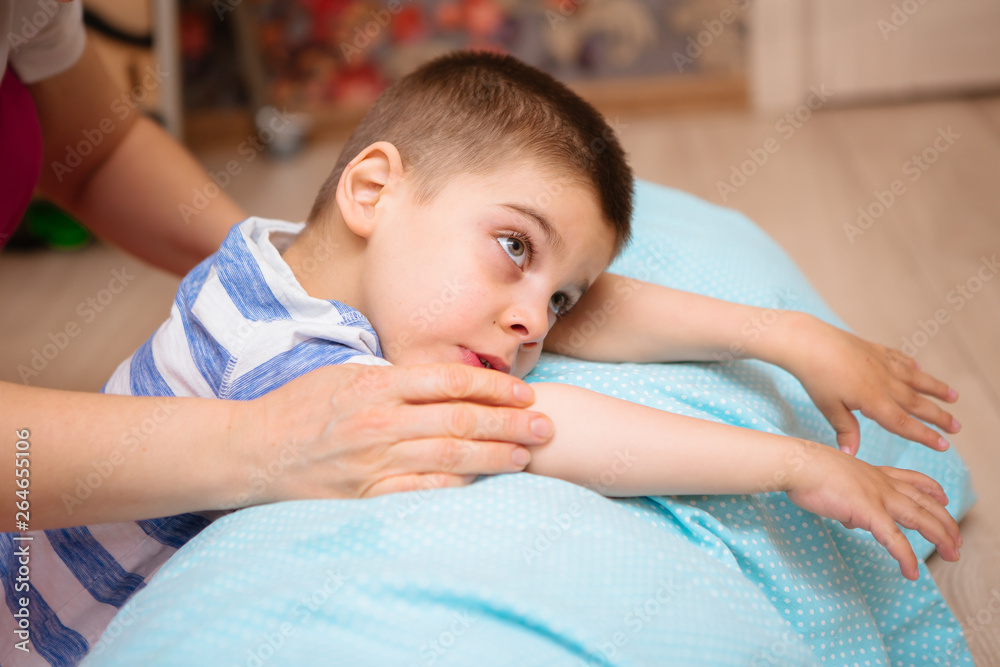little kid with cerebral palsy has musculoskeletal therapy by doing ...