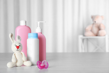 Wall Mural - baby accessories and toy on table against light background. space for text