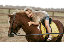 Adorable Little Girl Riding A Pony At Summer