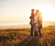 © JenkoAtaman - Happy family: mother, father, children son and daughter on sunset.