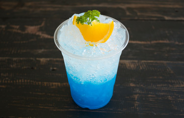 Blue Italian Soda Cold Beverage and Lemon Fruit and Parsley Center