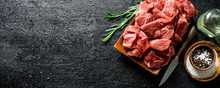 Cut Raw Beef With Spices In Bowl And Rosemary.