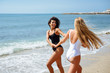 © javiindy - Two women in swimsuit having fun on the beach