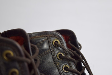 Close up of a brown old boots isolated on white background