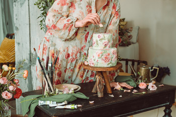 Wall Mural - Tea time, Woman hands holding tea pot, flowers and cake