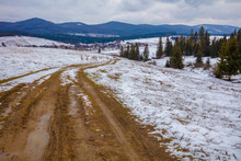 Mountain Landscape In Winter. Country Mountain Winding Road. The Dirt Road On The Hill