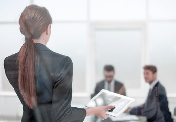 rear view.young business woman standing in front of office Board.