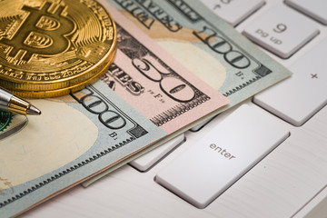 Closeup US banknote with coin and pen on keyboard for business concept