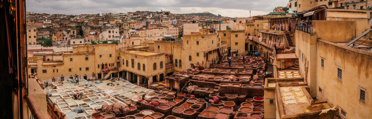 View inside of old medina in Fes, a traditional and old tannery with workers working making methods of leather in the city Fes, Morocco, in april of 2019. 