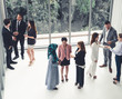 © InfiniteFlow - Many business people gathering in modern office building for business conference in the city. Businessmen and businesswomen communication and human resources concept.