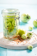 Homemade Pickled Green Tomatoes In The Jar On Wooden Table