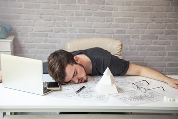 man designers sleeping because of fatigue from work.