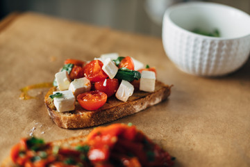 Canvas Print - Cherry tomatoes with basil and cheese served on a toasted bread