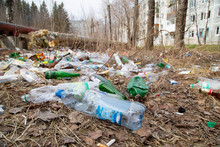 Garbage In The Forest. Plastic And Glass Bottles In The Park.