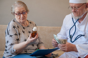 House doctor man in glasses came home to elderly woman pensioner. Doctor prescribes pills, gives prescription, shows various pills. Doctor sells medicine to woman.