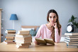 © BestForYou - Woman student reading books at the table.