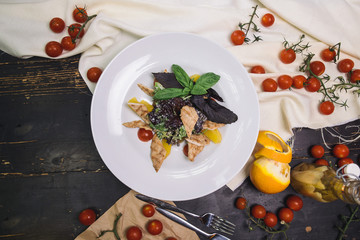 Wall Mural - salad with grilled chicken fillet, basil, cherry tomatoes and orange in a white plate.