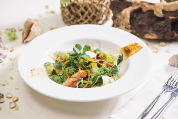 Canvas Print - salad with eel and cucumber on a white plate