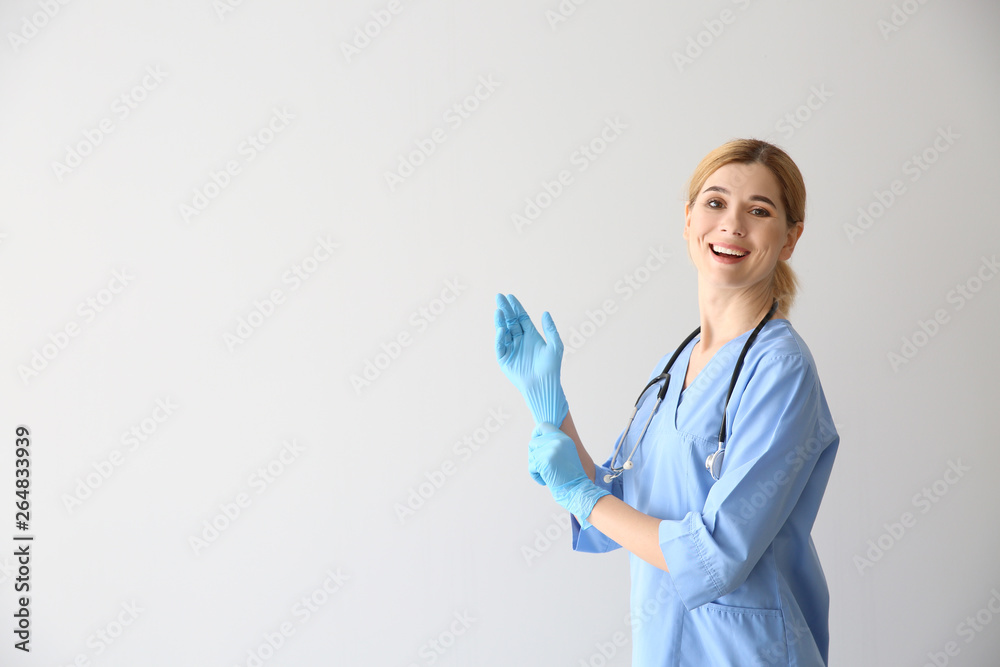 Portrait of beautiful gynecologist on light background