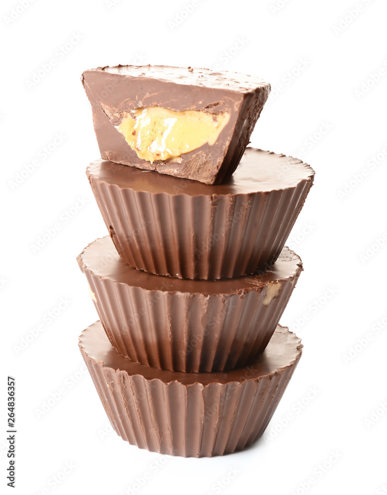 Tasty chocolate peanut butter cups on white background