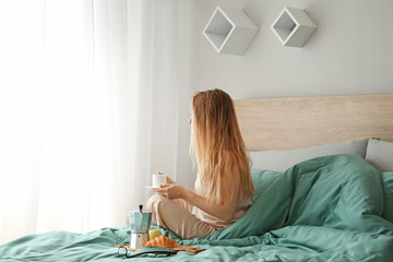 Sticker - Young woman having breakfast on bed