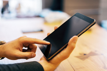 Poster - Sideview of businessman using tablet