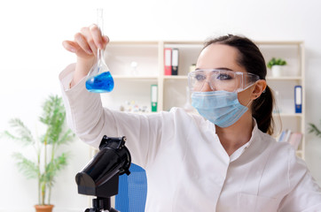 Young female chemist working in the lab 