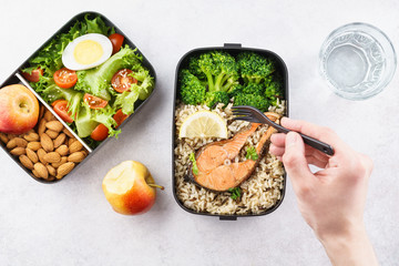 Wall Mural - Man eating nutrition lunch from takeaway lunch box.